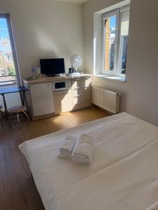 a bedroom with a bed with two towels on it at Palanga Old Town in Palanga +9 photos