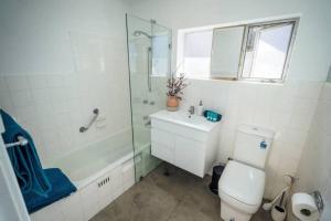a bathroom with a shower and a toilet and a sink at Anzac Hwy near airport, beach in Plympton