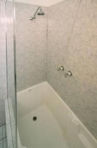 a shower with a white tub in a bathroom at 2BR unit at Glenelg Beach in Glenelg