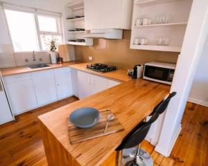 a kitchen with a wooden table with a bowl on it at 2BR unit at Glenelg Beach in Glenelg