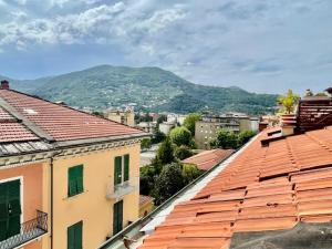a view of a city with buildings and a mountain at Tino'S House 2punto0 in La Spezia