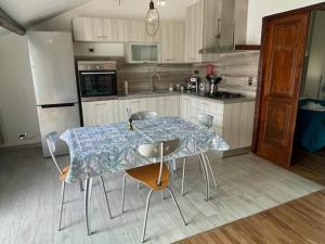 a kitchen with a table and chairs in a kitchen at Tino'S House 2punto0 in La Spezia +6 photos