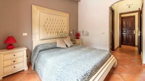 a bedroom with a large bed and a mirror at Villa Delle Palme Delfina in Trapani +190 photos