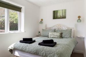 a bedroom with a bed with two pillows on it at 'Haworth Haven', Warm Winter Cottage Getaway in Haworth