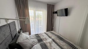 Posteľ alebo postele v izbe v ubytovaní Apartament GreyAppart