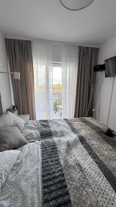 Posteľ alebo postele v izbe v ubytovaní Apartament GreyAppart