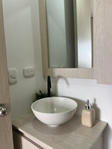a bathroom with a white bowl sink on a counter at CENTRO historico y CC FUNDADORES in Manizales