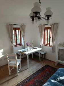 a white table and chairs in a room with windows at Pferdehof in der Oststeiermark in Elxenbach +17 photos