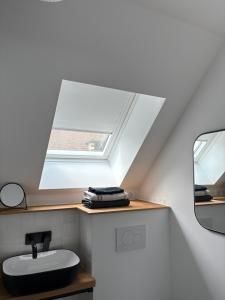 a bathroom with a sink and a skylight at Studio Fourchaume in Chablis