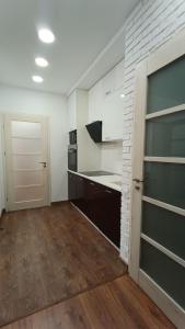 a room with a kitchen with a counter and a door at VIP Apartments 9 in Odesa