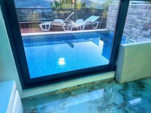 a view of a swimming pool through a window at Villa Nova Bar in Zaljevo