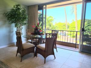 Un comedor con mesa y sillas y un balcón. en Maui Kaanapali Villas 408 condo, en Lahaina
