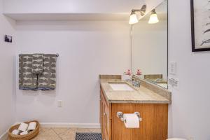 a bathroom with a sink and a mirror at Fish and Hike Apartment with Pool Table in Ketchikan! in Ketchikan +17 photos