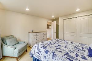 a bedroom with a bed and a chair and a dresser at Fish and Hike Apartment with Pool Table in Ketchikan! in Ketchikan