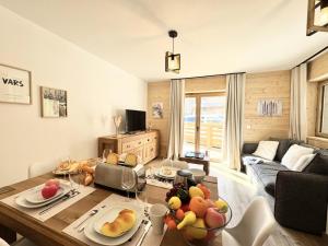 a living room with a table with fruit on it at Résidence Le Living Stone B - T3 RESIDENCE NEUVE, CENTRE VARS, 150m DES PISTES MAE-7681 in Vars +8 photos