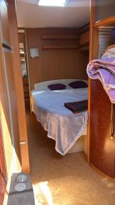 a small room with a bed on a boat at TOP LAGE 2 Personen Volkach Wohnwagen Luxus in Volkach