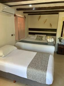 Postel nebo postele na pokoji v ubytování Hotelito Crismi