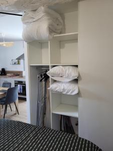 a room with a bed and some pillows on shelves at Un Bibou de Campagne 1 in Le Theil-de-Bretagne +5 photos