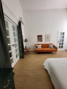 a room with a bed and a couch in it at Casa Ianca in Lecce +22 photos