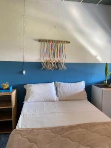 a bedroom with a bed with a blue wall at Chalés Vale Encantado -Serra do Cipó- in Jaboticatubas +53 photos