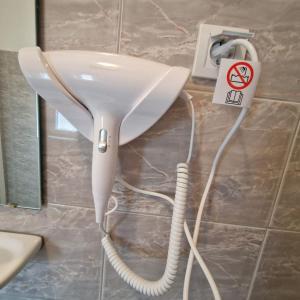 a white hair dryer plugged into a wall at Vila Natasa Apartment 5 near Plitvice in Vrhovine +31 photos