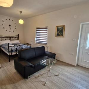 a living room with a couch and a bed at Vila Natasa Apartment 5 near Plitvice in Vrhovine