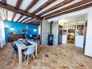 a living room with blue walls and a table and chairs at Holiday Home Proche Océan- forêt et commerces by Interhome in Fromentine