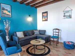 a living room with a couch and a table and chairs at Holiday Home Proche Océan- forêt et commerces by Interhome in Fromentine
