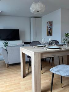 a living room with a table with wine glasses on it at Alexander Home with parking in Colmar