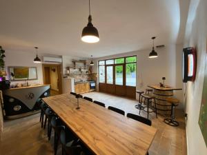 a large wooden table and chairs in a kitchen at Casa Tilia in Omar