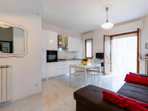 a kitchen and living room with a couch and a table at Apartment Casa del Mare by Interhome in Diano Marina