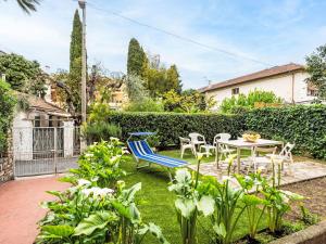a patio with a table and chairs in a garden at Apartment Casa del Mare by Interhome in Diano Marina