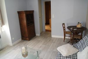 a living room with a table and a candle on a glass table at Gite de la Croix in Briantes +7 photos
