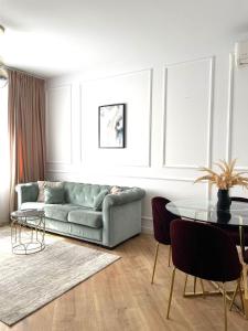 a living room with a couch and a table at Luxury Pipera in Voluntari