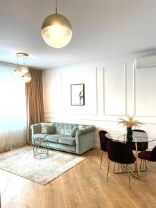 a living room with a couch and a table at Luxury Pipera in Voluntari