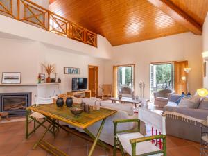 a living room with a couch and a table at Holiday Home Refúgio no Montalvo by Interhome in Alcácer do Sal