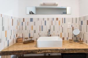 a bathroom with a white sink and a mirror at Appartement plein centre "En Appart'é" in Signy-lʼAbbaye
