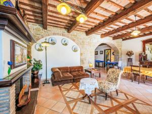 a living room with a couch and a table at Holiday Home Giuncheto-1 by Interhome in Pilonico Paterno +23 photos