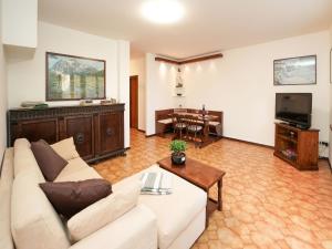 a living room with a couch and a table at Holiday Home Re-Ri by Interhome in Laveno-Mombello