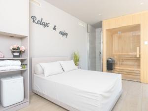 a bedroom with a white bed and a sign on the wall at Holiday Home Villa Romantica by Interhome in Nedeščina