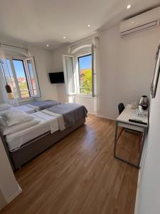 a bedroom with a large bed and a table at Soukki Town Centre Suites 2 in Split