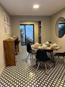 a dining room with a table and chairs and a mirror at Casa Martina Manga Cartagena in Cartagena de Indias