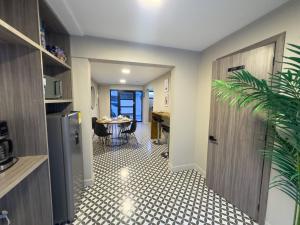 a hallway with a room with a table and a refrigerator at Casa Martina Manga Cartagena in Cartagena de Indias +28 photos