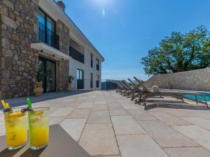 a couple of drinks sitting on a table next to a building at Villa Vila 21 by Interhome in Bribir