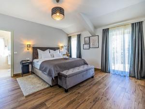a bedroom with a large bed and a large window at Villa Vila 21 by Interhome in Bribir