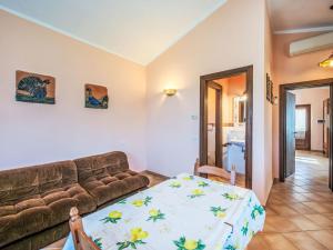 a living room with a couch and a table at Holiday Home Giuncheto-2 by Interhome in Pilonico Paterno +22 photos