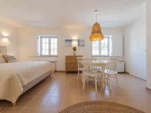 a bedroom with a bed and a table and chairs at Apartment Natura Bliss Studio by Interhome in Alcácer do Sal