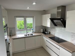 a kitchen with white cabinets and a sink at TheBeautifulView in Saint-Louis
