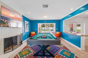 a living room with a pool table and a fireplace at Heated Pool Pickleball Mini Golf — Sleeps 20 in Clearwater