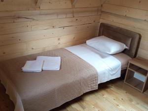 a bedroom with a bed with two towels on it at Camp River in Virpazar +41 photos
